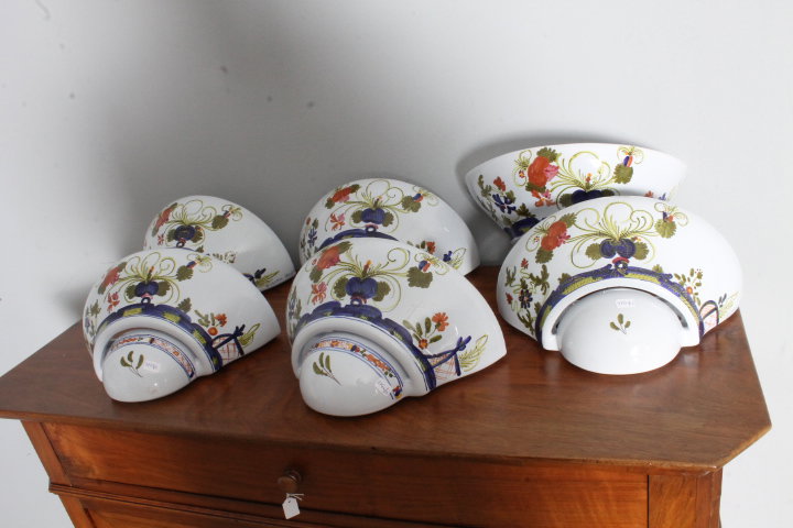 Group of six Faenza-style painted ceramic wall sconces, signed Giordano.